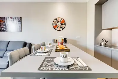 a kitchen and dining room with a long table and a clock at Vatican Guest House in Rome