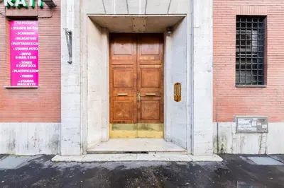a wooden door on the side of a building at Vatican Guest House in Rome