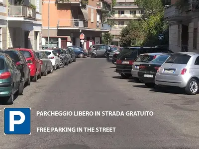 a bunch of cars parked on the side of a street at The Pope At The Window in Rome