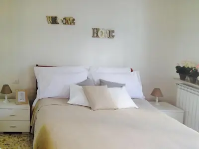a bedroom with a white bed with white pillows at The Pope At The Window in Rome