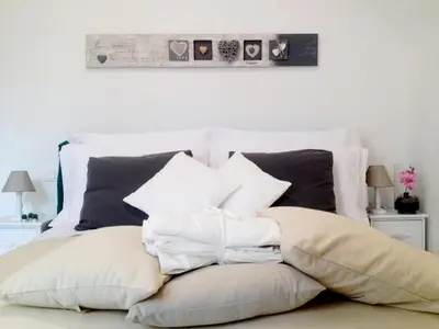a bed with a bunch of pillows on it at The Pope At The Window in Rome