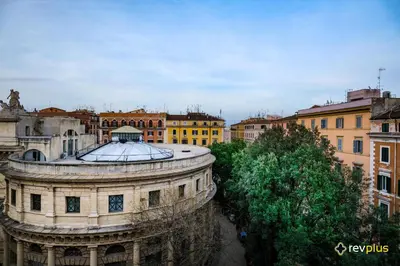 an old building with a dome in a city at Magic Double in Rome