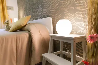 a bedroom with a bed with a lamp on a side table at Magic Double in Rome