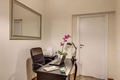 an office with a desk with a laptop and a mirror at YH SUITE 131 in Rome