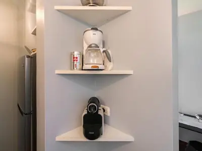 a kitchen with white shelves with a tea kettle on them at Garibaldi Roof Garden in Rome