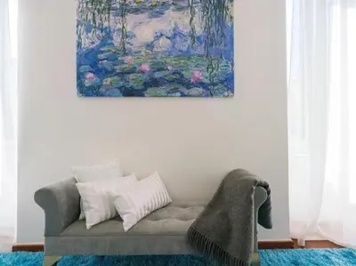 a couch in a living room with a painting on the wall at Garibaldi Roof Garden in Rome