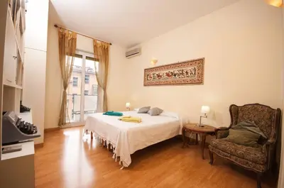 a bedroom with a bed and a chair at Vatican Balcony in Rome