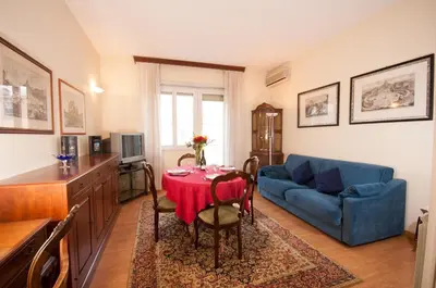 a living room with a table and a blue couch at Vatican Balcony in Rome