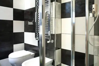 a bathroom with a toilet and a glass shower at The Green Corner in Rome