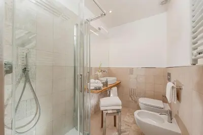 a bathroom with a shower and a toilet and a sink at Colosseum Corner in Rome
