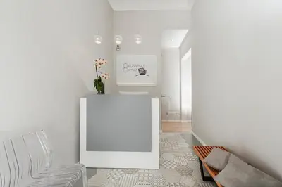 a white room with a table and a chair at Colosseum Corner in Rome