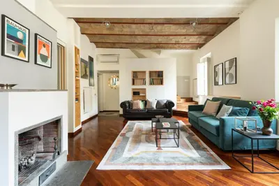 a living room with a couch and a fireplace at Trevi Charming Penthouse in Rome