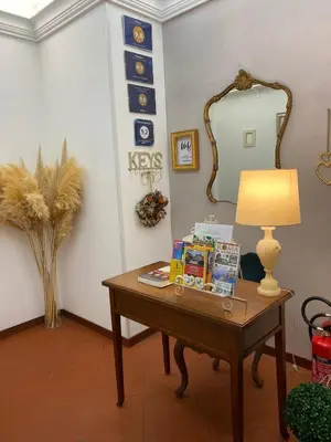 a room with a table with a lamp and a mirror at Al Ponte Del Papa B&B in Rome