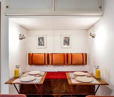 a dining room with two tables and orange towels at Al Ponte Del Papa B&B in Rome