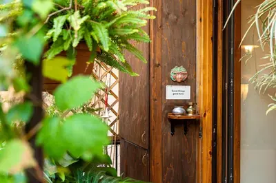 a wooden door with a sign on it with plants at Al Ponte Del Papa B&B in Rome