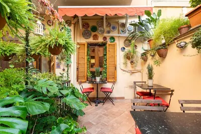 a patio with a table and chairs and plants at Al Ponte Del Papa B&B in Rome