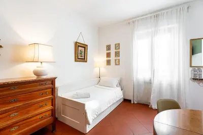 a bedroom with a bed and a dresser and a table at Al Ponte Del Papa B&B in Rome