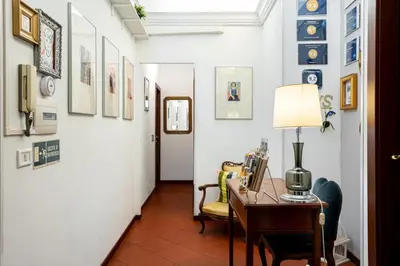 a hallway with a desk and chairs in a room at Al Ponte Del Papa B&B in Rome