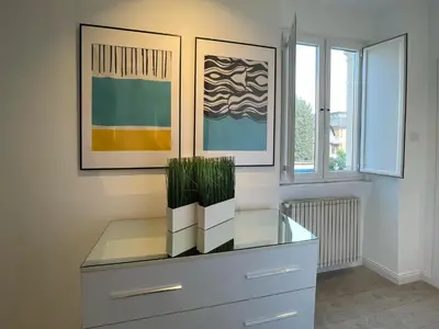 a dresser with plants on top of it in a room at Vatican Holiday Apartment 317 in Rome