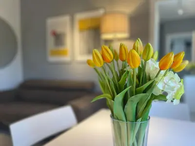 a vase filled with yellow flowers on a table at Vatican Holiday Apartment 317 in Rome