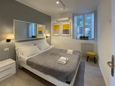 a bedroom with a large bed with two towels on it at Vatican Holiday Apartment 317 in Rome