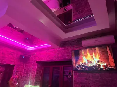 a room with a fireplace and purple lights at Imperatore in Rome