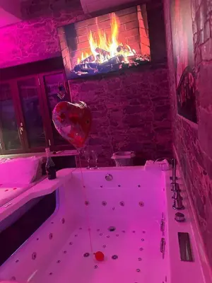 a bath tub with a heart balloon in front of a fireplace at Imperatore in Rome