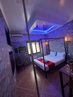 a bedroom with a bed in a stone wall at Imperatore in Rome