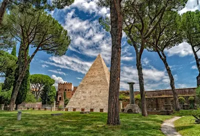 a pyramid in the middle of a park with trees at Imperatore in Rome