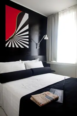 a bedroom with a large bed with a remote control at Sora Luxury Inn in Rome