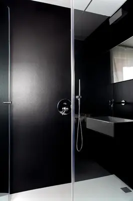 a glass shower door in a bathroom with a sink at Sora Luxury Inn in Rome