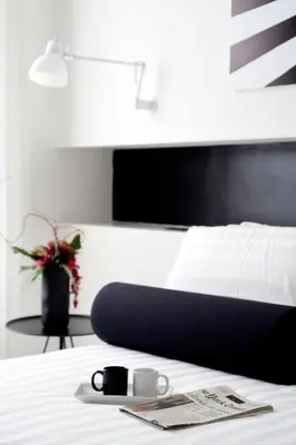 a bedroom with a bed with a black and white headboard at Sora Luxury Inn in Rome