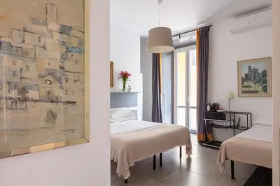 a hotel room with two beds and a wall at Residenza Ottaviano 105 by Hili in Rome