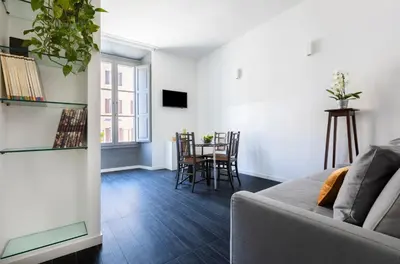 a living room with a couch and a table at Residenza Ottaviano 105 by Hili in Rome