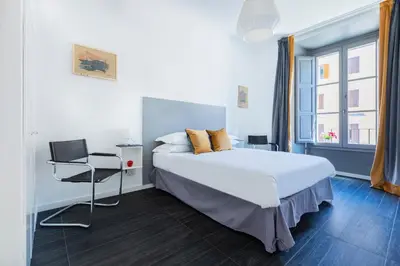 a bedroom with a large bed and a window at Residenza Ottaviano 105 by Hili in Rome