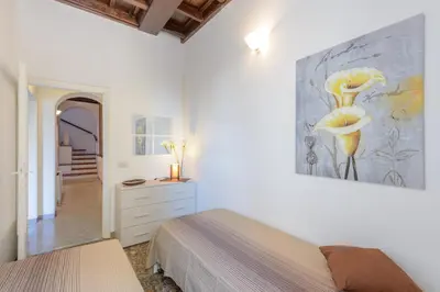 a bedroom with a bed and a painting on the wall at Appartamento Castel Sant'Angelo in Rome