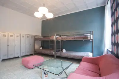 a living room with bunk beds and a glass table at Sarah's House - Tourist Accommodation in Rome