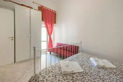 a bedroom with a bed with two towels on it at Sarah's House - Tourist Accommodation in Rome