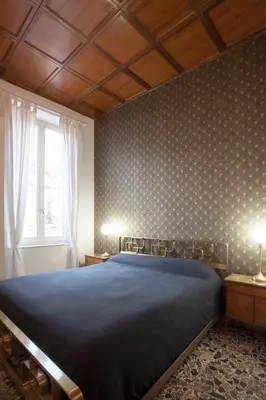 a bedroom with a bed and two lamps on tables at Sarah's House - Tourist Accommodation in Rome