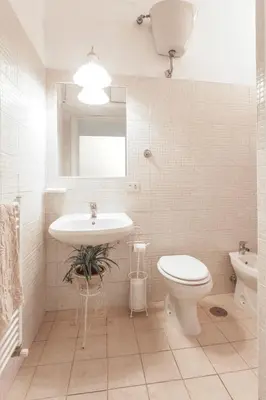 a white bathroom with a sink and a toilet at Sarah's House - Tourist Accommodation in Rome