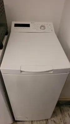 a white dishwasher in a corner of a room at Loft in San Pietro in Rome