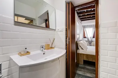 a bathroom with a sink and a mirror at Chiavari Apartment in Rome