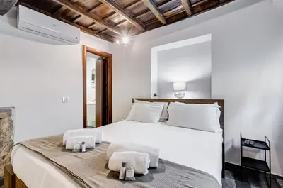 a bedroom with a large white bed with towels on it at Chiavari Apartment in Rome