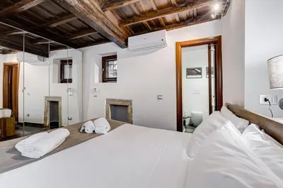 a bedroom with a white bed with two towels on it at Chiavari Apartment in Rome