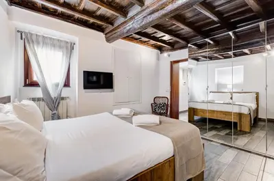 a bedroom with two beds and a sink at Chiavari Apartment in Rome