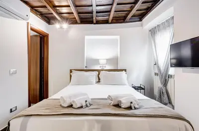a bedroom with a bed with towels on it at Chiavari Apartment in Rome