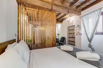 a bedroom with a white bed and a window at Chiavari Apartment in Rome