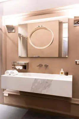 a bathroom with a sink and a mirror at Le Quattro Dame Luxury Suites in Rome