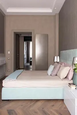 a bedroom with a large bed with pink pillows at Le Quattro Dame Luxury Suites in Rome