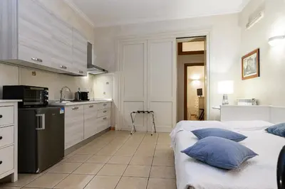 a kitchen with two beds in a room at Apartment Julia Guesthouse Trevi - Spagna in Rome